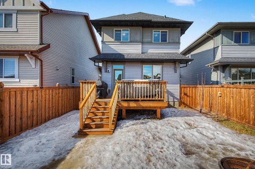 Rear view of property with a shingled roof, a fenced backyard, and a wooden deck - 4110 Allan Crescent, Edmonton, AB - Outdoor
