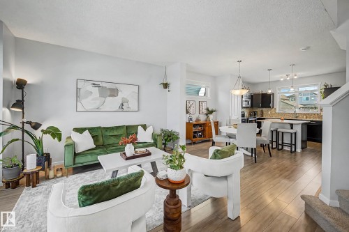 Living room featuring light wood-style flooring and a textured ceiling - 4110 Allan Crescent, Edmonton, AB - Indoor Photo Showing Living Room