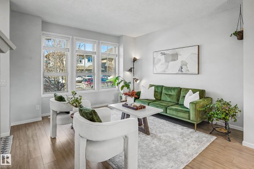 Living room with light wood-style floors and a textured ceiling - 4110 Allan Crescent, Edmonton, AB - Indoor Photo Showing Living Room
