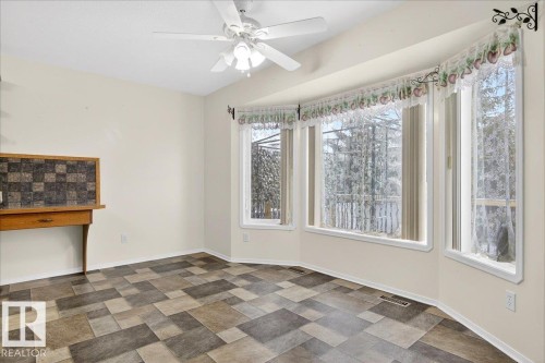 This bright room features a bay window, a ceiling fan, and tiled flooring - 4412 Yeoman Close, Onoway, AB - Indoor Photo Showing Other Room