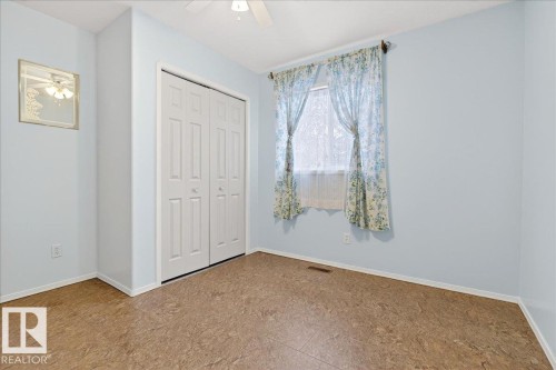 This room features light blue walls, a window with curtains, and a ceiling fan - 4412 Yeoman Close, Onoway, AB - Indoor Photo Showing Other Room