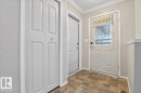 Entryway featuring patterned floor tiles, a white door with a decorative glass insert, and a white bi-fold door - 4412 Yeoman Close, Onoway, AB  - Indoor Photo Showing Other Room 