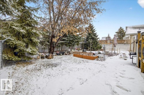 The property features a large yard with mature trees and a raised garden bed - 4412 Yeoman Close, Onoway, AB - Outdoor