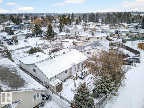 The property features a backyard with a wooden deck and a storage shed - 4412 Yeoman Close, Onoway, AB - Outdoor With View