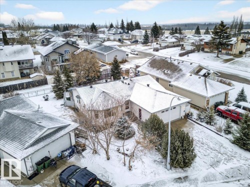 The property features a white exterior, an attached garage, and a driveway - 4412 Yeoman Close, Onoway, AB - Outdoor With View