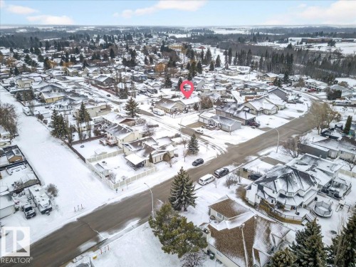 Aerial view of the property and its surrounding area, featuring paved streets and established trees - 4412 Yeoman Close, Onoway, AB - Outdoor With View