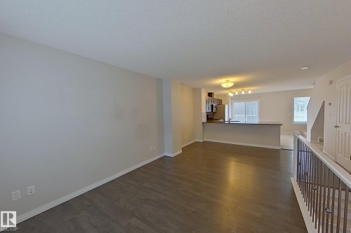 Open concept living space featuring wood-look flooring and light-colored walls - 87 4050 Savaryn Drive, Edmonton, AB - Indoor Photo Showing Other Room