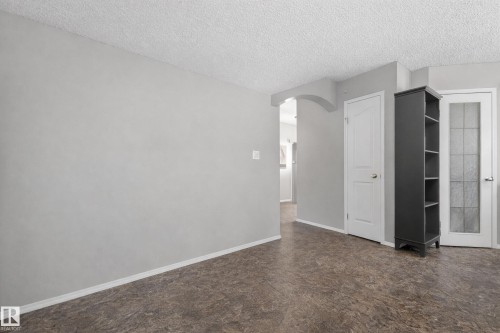 The interior features light gray walls, white baseboards, and a textured ceiling - 8109 85 Street, Edmonton, AB - Indoor Photo Showing Other Room