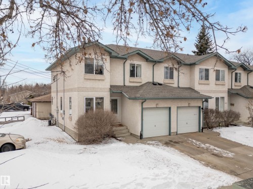 The property features a two-story exterior with a light-colored stucco finish and a shingled roof - 8109 85 Street, Edmonton, AB - Outdoor With Facade