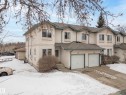 The property features a two-story exterior with a light-colored stucco finish and a shingled roof - 8109 85 Street, Edmonton, AB  - Outdoor With Facade 