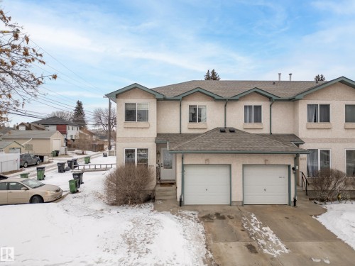 Exterior view of the property, featuring a two-car garage, a paved driveway, and a snow-covered lawn - 8109 85 Street, Edmonton, AB - Outdoor With Facade