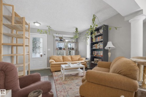 The living area features hardwood floors and light gray walls - 8109 85 Street, Edmonton, AB - Indoor Photo Showing Living Room