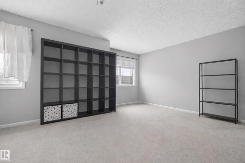 This room features light grey walls and light colored carpeting - 8109 85 Street, Edmonton, AB - Indoor