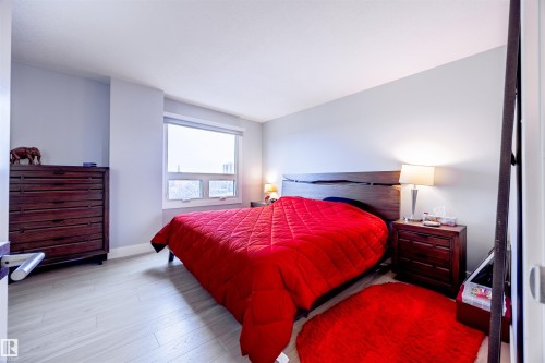 Well-lit room featuring light-toned flooring and a window providing natural illumination - 803 12303 Jasper Avenue, Edmonton, AB - Indoor Photo Showing Bedroom