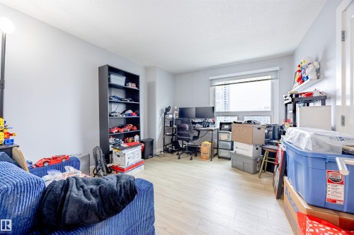 The property features light-colored flooring and a large window, providing natural light - 803 12303 Jasper Avenue, Edmonton, AB - Indoor