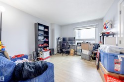 The property features light-colored flooring and a large window, providing natural light - 