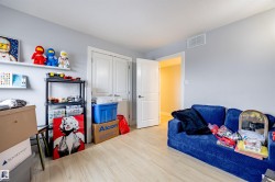 This room features light-colored flooring, a light gray wall color, and a white door frame - 