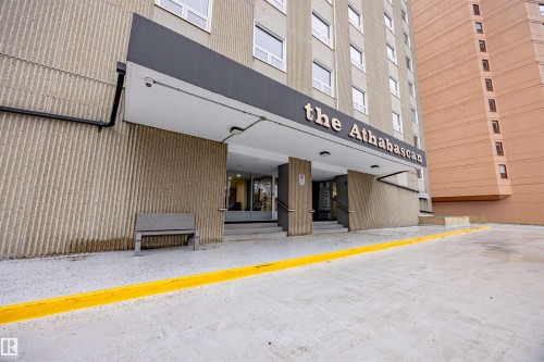 The property features a concrete exterior with a prominent entrance canopy - 803 12303 Jasper Avenue, Edmonton, AB - Outdoor