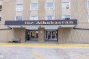 The property features a prominent building entrance with a clear sign, a concrete facade, and multiple windows - 803 12303 Jasper Avenue, Edmonton, AB  - Outdoor 