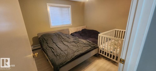 This room features light-colored walls and flooring, with a window providing natural light - 204 11218 80 Street, Edmonton, AB - Indoor Photo Showing Bedroom