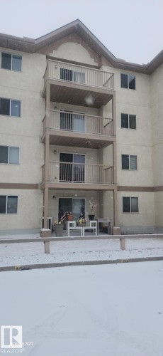 The property features multi-level balconies with railings, and sliding glass doors - 204 11218 80 Street, Edmonton, AB - Outdoor With Balcony