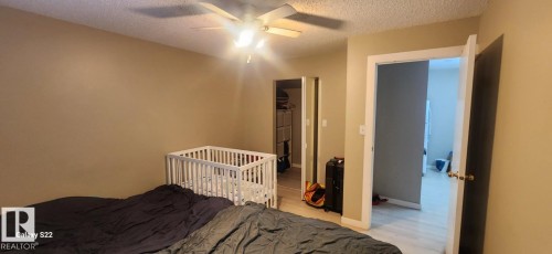 This room features light tan walls and a ceiling fan with integrated lighting - 204 11218 80 Street, Edmonton, AB - Indoor Photo Showing Bedroom