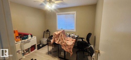 The room features neutral-toned walls, a window with blinds, and a ceiling fan with integrated lighting - 204 11218 80 Street, Edmonton, AB - Indoor