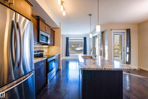 117 10523 123 Street, Edmonton, AB - Indoor Photo Showing Kitchen With Stainless Steel Kitchen With Double Sink With Upgraded Kitchen