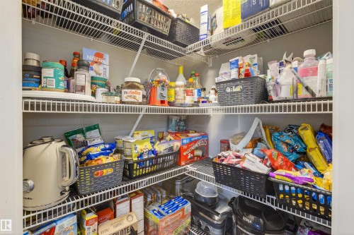 This pantry features extensive wire shelving, providing ample storage space - 134 148 Ebbers Boulevard, Edmonton, AB - Indoor With Storage