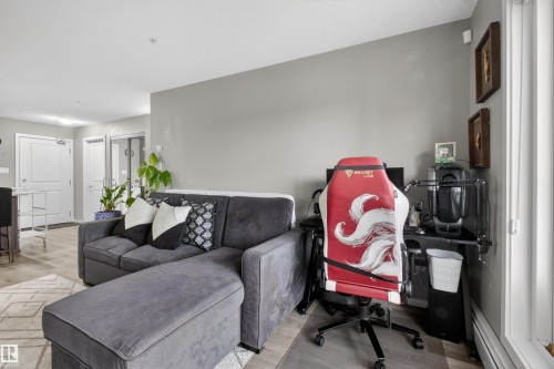 Living area with light-colored flooring, grey walls, and a white ceiling - 134 148 Ebbers Boulevard, Edmonton, AB - Indoor Photo Showing Living Room