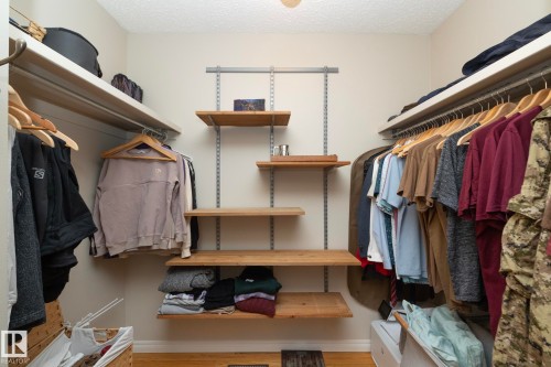 Walk-in closet featuring extensive built-in shelving and hanging rails, providing ample storage - 54 Beaverbrook Crescent, St. Albert, AB - Indoor With Storage