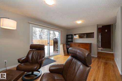 Spacious living area featuring hardwood flooring, recessed lighting, and a sliding glass door providing natural light and exterior access - 54 Beaverbrook Crescent, St. Albert, AB - Indoor