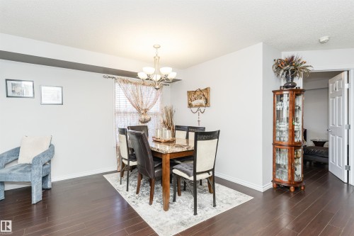 The dining area features dark wood flooring and light-colored walls - 107 10118 106 Avenue, Edmonton, AB - Indoor Photo Showing Dining Room