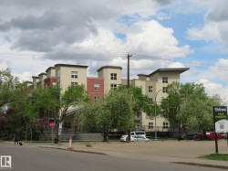 Multi-story building featuring a contemporary facade with varying warm-toned stucco finishes and multiple window placements - 