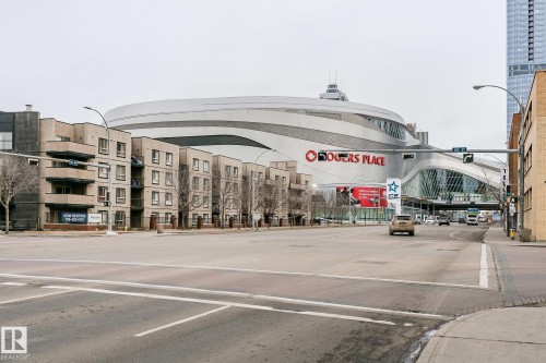The property is situated within a vibrant urban setting, featuring multi-story residential buildings - 107 10118 106 Avenue, Edmonton, AB - Outdoor