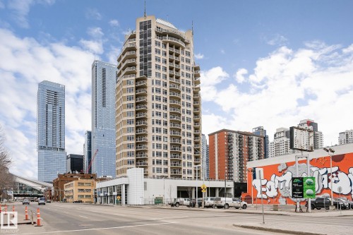 The property is a high-rise building with numerous balconies, situated in an urban environment with other high-rise buildings and commercial properties visible - 107 10118 106 Avenue, Edmonton, AB - Outdoor With Facade