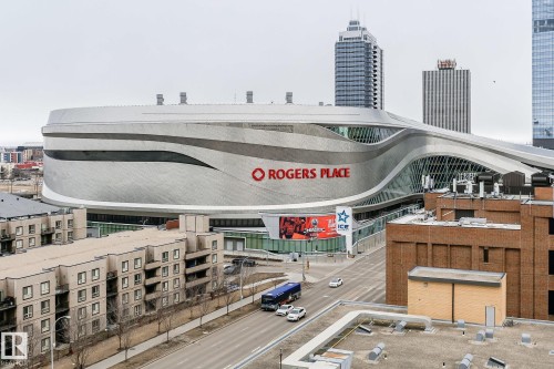 The property is located in a vibrant urban setting with views of a modern stadium and surrounding cityscape - 107 10118 106 Avenue, Edmonton, AB - Outdoor