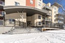 The property features a prominent covered entrance with a modern design, providing sheltered access - 107 10118 106 Avenue, Edmonton, AB  - Outdoor 