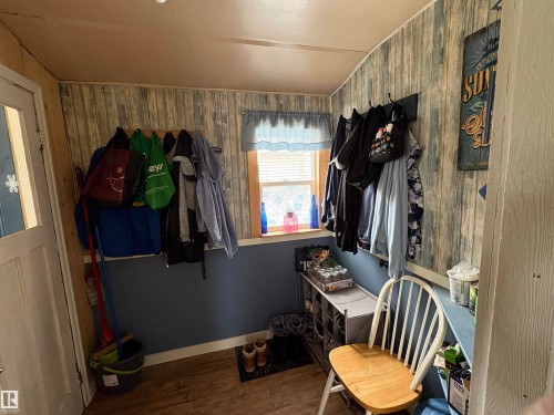 Entryway with wood-look flooring and a window providing natural light. - 5117 52 Avenue, Elk Point, AB - Indoor