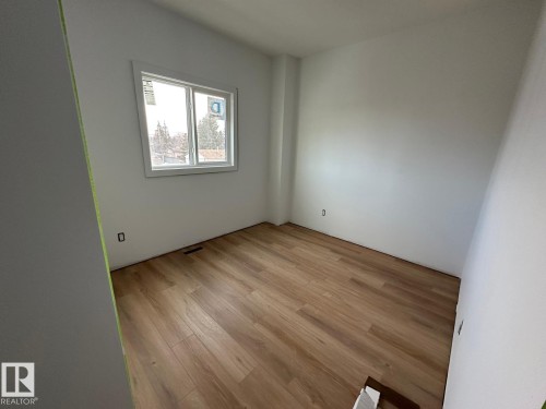 This room features light wood-style flooring and a window providing natural light - 9214 152 Street, Edmonton, AB - Indoor Photo Showing Other Room