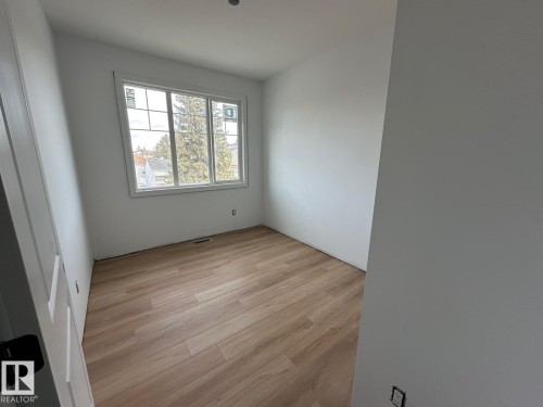 This room features light-toned wood flooring and a window providing natural light - 9214 152 Street, Edmonton, AB - Indoor Photo Showing Other Room