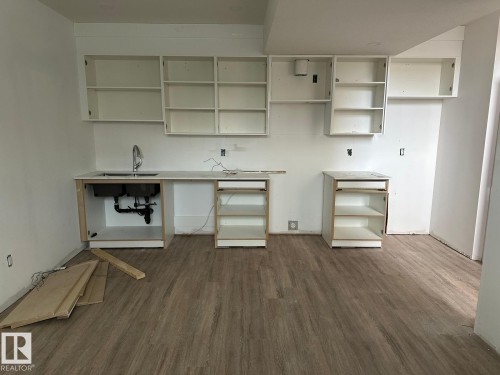 Kitchen area featuring light-colored flooring, white walls, and white cabinetry - 9214 152 Street, Edmonton, AB - Indoor Photo Showing Other Room