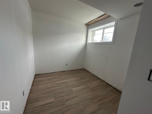 Room with light-toned flooring and a window providing natural light - 9214 152 Street, Edmonton, AB - Indoor Photo Showing Other Room