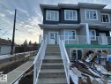 The property features a modern exterior with varied siding, white window frames, and a concrete staircase leading to the entrance - 9214 152 Street, Edmonton, AB  - Outdoor With Facade 