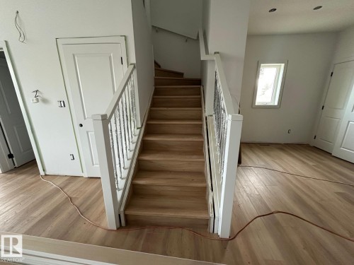 The property features a staircase with light wood treads and white balusters - 9214 152 Street, Edmonton, AB - Indoor Photo Showing Other Room