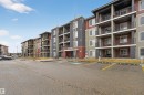 Multi-story apartment building with balconies, featuring varied exterior siding and stone accents - 311 12035 22 Avenue, Edmonton, AB  - Outdoor With Balcony With Facade 