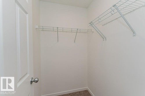 Well-lit closet space featuring wire shelving and carpeted flooring - 9652 Colak Link Link, Edmonton, AB - Indoor With Storage