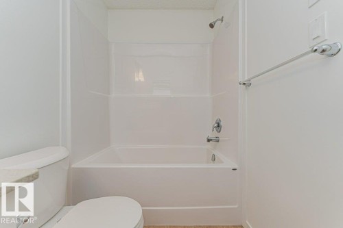 Bathroom featuring a shower and bathtub combination with chrome fixtures - 9652 Colak Link Link, Edmonton, AB - Indoor Photo Showing Bathroom