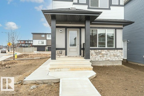 The property features a contemporary exterior with light-colored siding, dark trim accents, and a stone facade - 9652 Colak Link Link, Edmonton, AB - Outdoor