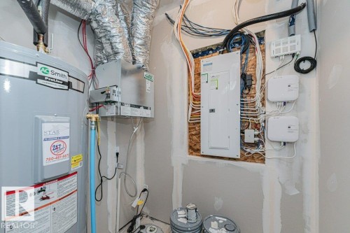 The property includes a water heater, an electrical panel, and various utility connections - 9652 Colak Link Link, Edmonton, AB - Indoor Photo Showing Basement